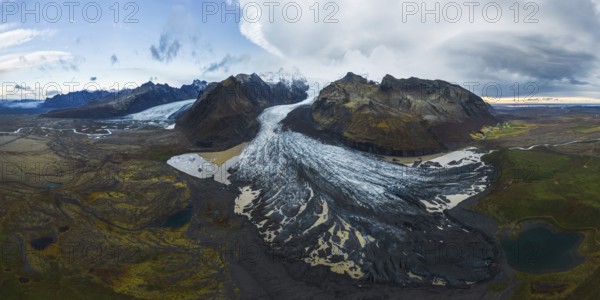 Aerial view of Vatnajokull Glacier, showcasing its expansive ice fields amidst rugged Icelandic terrain Captivating panoramic scenery highlighting nature's grandeur