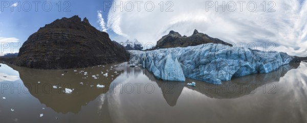 Panoramic view of Vatnajokull National Park's stunning ice formations, rugged mountains, and serene reflections Captures Iceland's pristine natural beauty and dramatic landscape