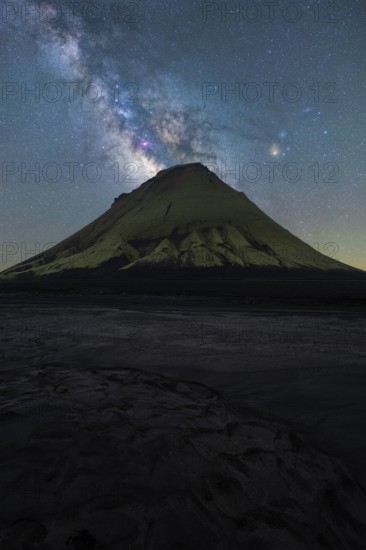 A striking view of an Icelandic mountain silhouetted against the vibrant Milky Way The serene night captures the magic of Northern nights in a breathtaking landscape