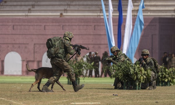 A sniffer dog accompanies personnel of the Central Reserve Police Force during a simulated counter-terror operation at the 87th Raising Day celebrations, on February 19, 2026 in Guwahati, India
