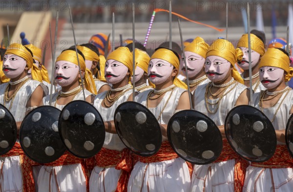 Artists in traditional attire perform a cultural martial dance with swords and shields during the 87th Raising Day celebrations, on February 19, 2026 in Guwahati, India