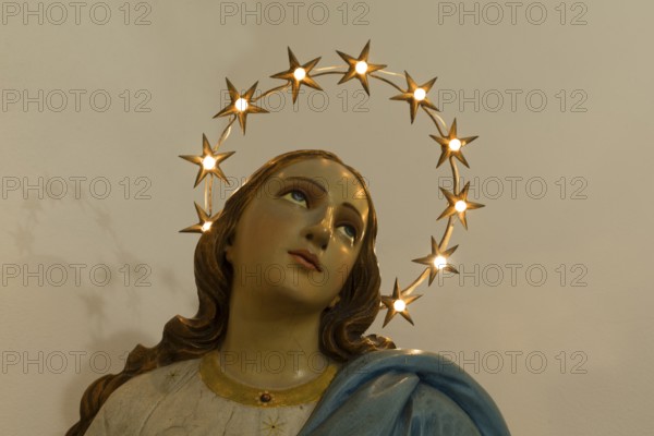 Wooden bust of St. Mary illuminated with a wreath of stars, Venice, Italy