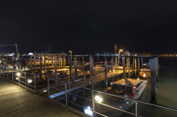 San Marco night-time boat dock, in the back the island of Saint Giorgio Maggiore, Venice, Veneto, Italy