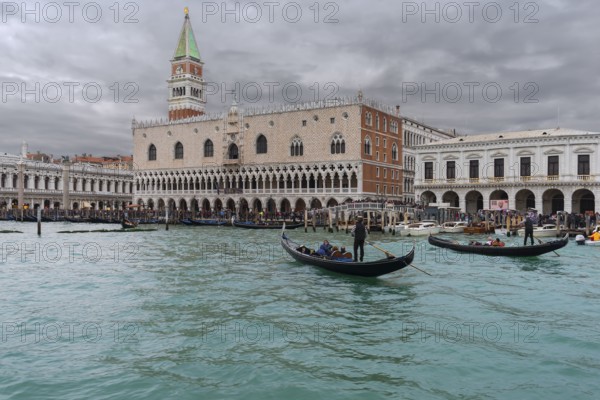 St. Mark's Square with Campanile and the Ducal Palace, in front gondola with tourists on the Grand Canal, Venice, Ventien, Italy