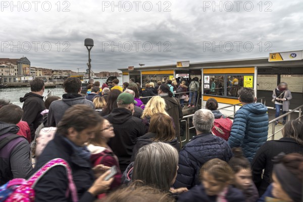 High season crowds at the vaporetto station, Venice, Veneto, Italy