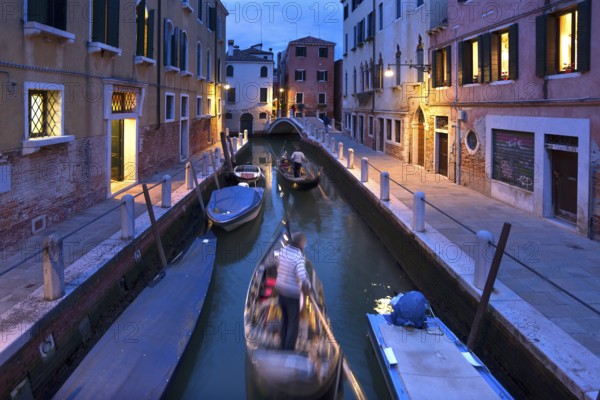 Gondolas in the evening in a side canal in the Dorsoduro district, Venice, Veneto, Italy