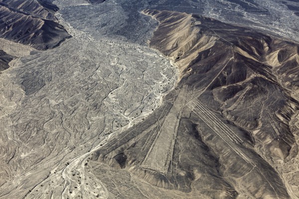 Desert mountain landscape with impressive Nazca lines from above in Peru, the geoglyphs and images in the desert near Nasca and Palpa in Peru