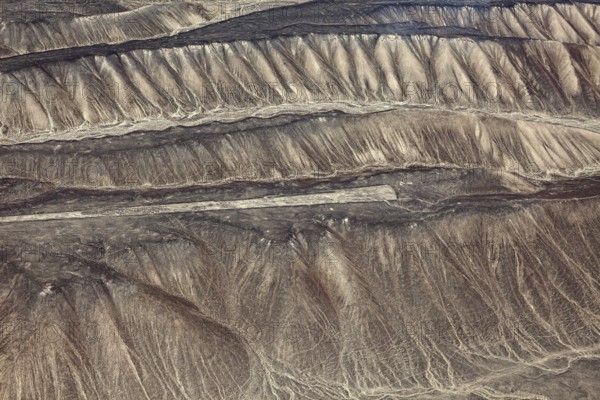 Aerial view of historic Nazca glyphs on the sandy hills of Peru, the geoglyphs and paintings in the desert near Nasca and Palpa in Peru