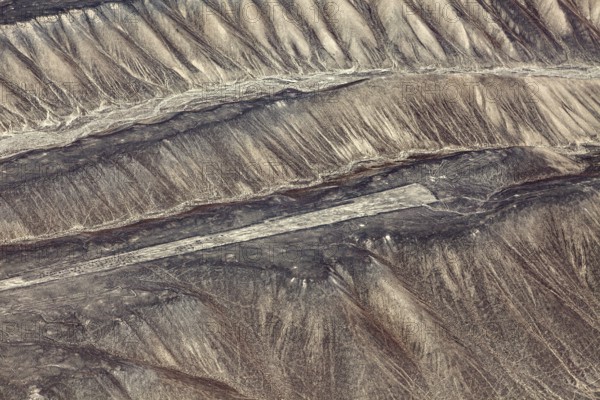 View of the mysterious Nazca Lines in Peru from above on sandy hills, the geoglyphs and paintings in the desert near Nasca and Palpa in Peru