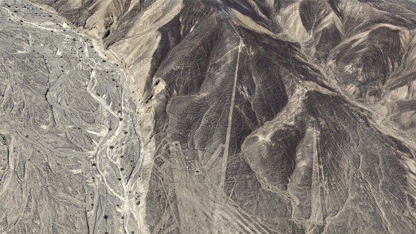 Aerial view of a desert landscape with complex line patterns and geoglyphs, the geoglyphs and images in the desert near Nasca and Palpa in Peru