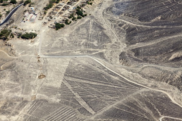 Aerial view of a dry desert landscape with the famous Nazca lines in Peru, the geoglyphs and images in the desert near Nasca and Palpa in Peru