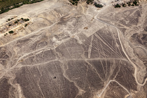 Nazca lines spread across the desert landscape in detailed patterns, the geoglyphs and drawings in the desert near Nasca and Palpa in Peru