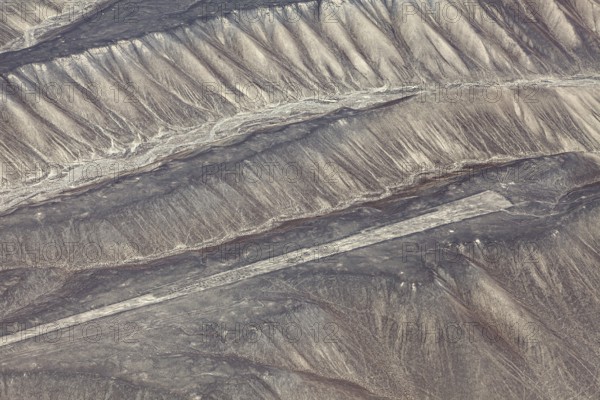 Aerial view of the drawn Nazca lines that cover sandy hills, the geoglyphs and drawings in the desert near Nasca and Palpa in Peru