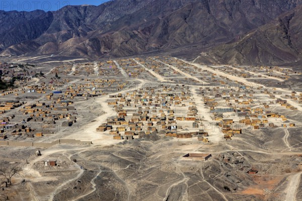 View of ordered settlements on the slopes of mountains in an arid region, the city of Nasca in Peru
