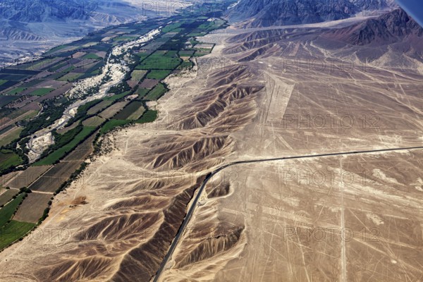 Contrasting landscape with dry desert, green fields and geoglyphs, the geoglyphs and drawings in the desert near Nasca and Palpa in Peru