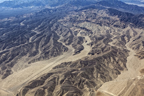 Ruffled mountain landscape in the desert with geoglyphs and sandy tones, The geoglyphs and paintings in the desert near Nasca and Palpa in Peru