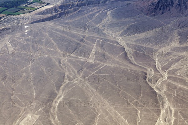 Aerial view of Nazca lines in a dry desert landscape with distinctive geoglyphs, the geoglyphs and images in the desert near Nasca and Palpa in Peru
