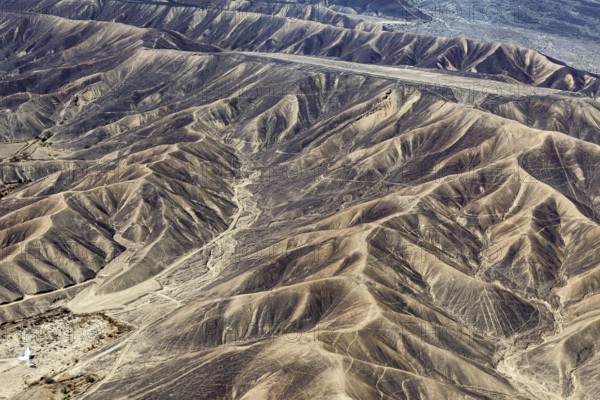 Barren range of hills with erosion-shaped structures in a dry environment, the desert landscape near Nasca in Peru