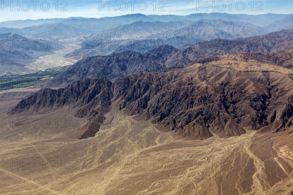 Impressive mountain formations in the midst of an extensive desert landscape from above, the desert landscape near Nasca in Peru