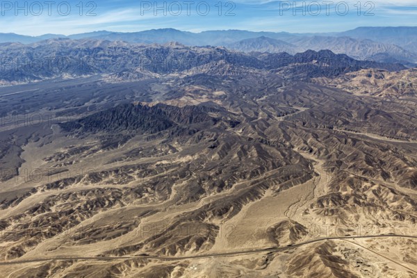 Extensive mountainous desert landscape with barren hills and valleys, the desert landscape near Nasca in Peru