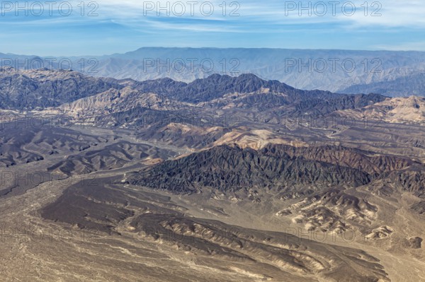 Hilly mountain landscape in a barren desert from a bird's eye view, The desert landscape near Nasca in Peru