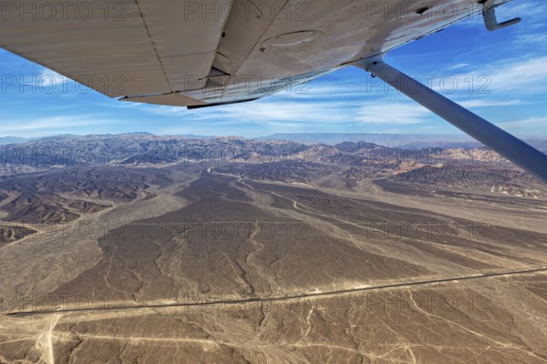Desert landscape with a view from an airplane, mountains and a clear blue sky, The desert landscape near Nasca in Peru