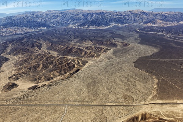View of vast desert plains and mountain ranges from the air, The desert landscape near Nasca in Peru