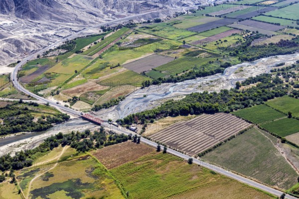 Picturesque green landscape with a river and a wooded road in the valley, The desert landscape near Nasca in Peru