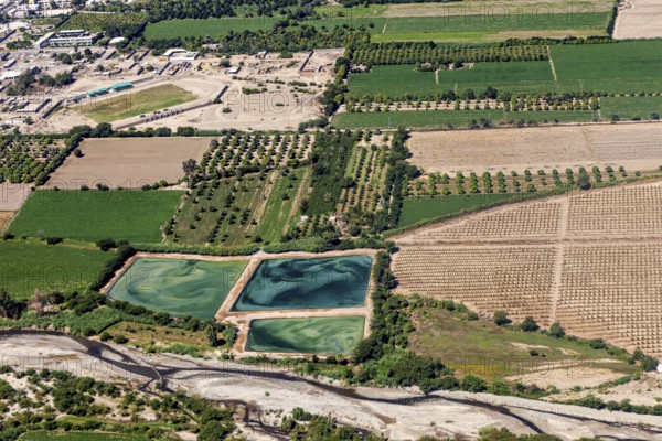 Structured agriculture with green fields and artificial lakes in the landscape, The desert landscape near Nasca in Peru