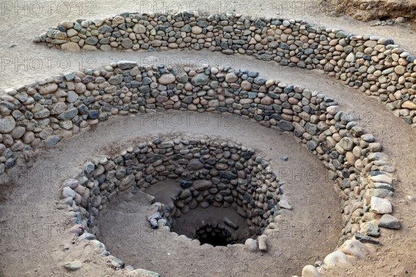 Stone spiral with evenly arranged layers of stone reaching into the earth, The ancient Nazca wells (puquios) near Nazca, Peru