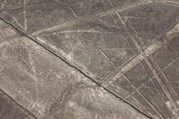 Geometric shapes and lines on a brown desert surface, the geoglyphs and drawings in the desert near Nasca and Palpa in Peru