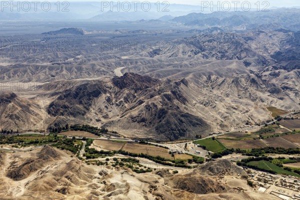 Landscape with mountains and green agricultural areas in the valley, The desert landscape near Nasca in Peru