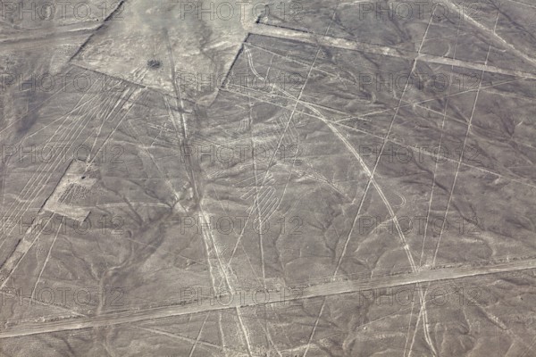 Aerial view of the Nazca lines with visible geometric shapes in the desert, the geoglyphs and images in the desert near Nasca and Palpa in Peru