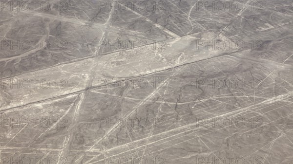 Aerial view of the Nazca lines in a barren desert landscape with geometric patterns, the geoglyphs and images in the desert near Nasca and Palpa in Peru