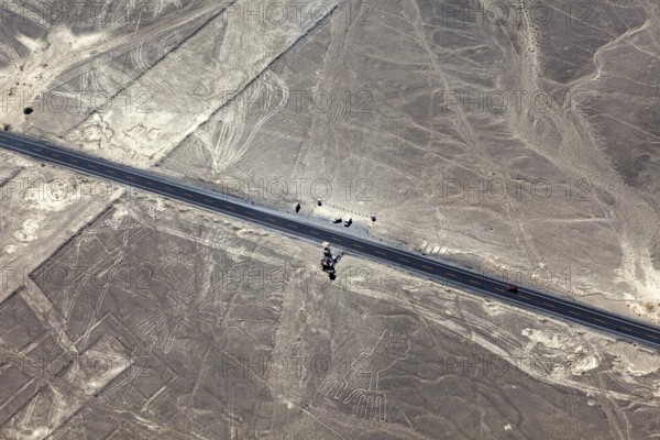 Road through a desert with ancient lines and shapes in the area, the geoglyphs and paintings in the desert near Nasca and Palpa in Peru