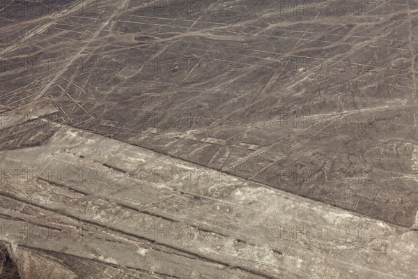 Nazca lines visible from the air with geometric shapes on barren desert soil, the geoglyphs and drawings in the desert near Nasca and Palpa in Peru