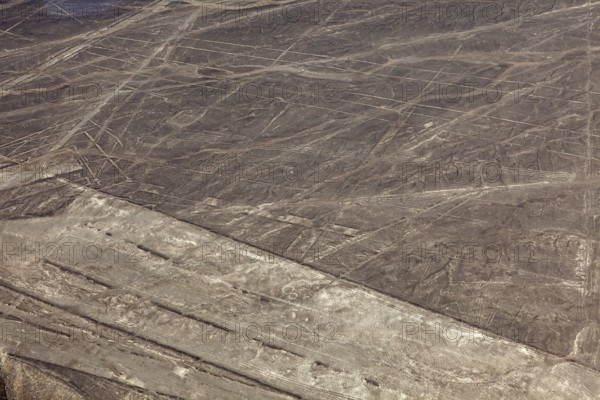 Nazca lines in a dry desert landscape with recognizable patterns, the geoglyphs and drawings in the desert near Nasca and Palpa in Peru