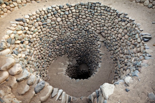Tightly wound spiral of stones that reaches deep into the ground, The ancient Nazca wells (puquios) near Nazca, Peru