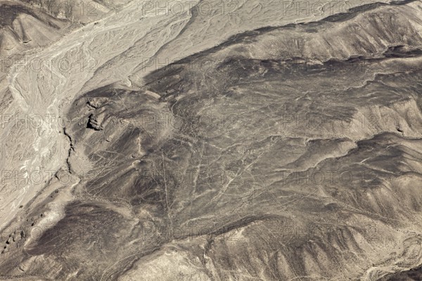 Dry desert with puzzling lines that cover the mountain and form geometric figures, the geoglyphs and drawings in the desert near Nasca and Palpa in Peru