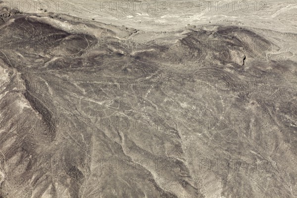 View of barren desert landscape with visible ancient line patterns, geoglyphs and drawings in the desert near Nasca and Palpa in Peru