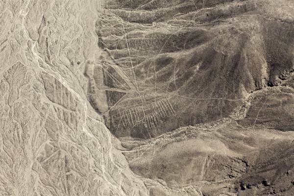 Aerial view of line patterns that run through the inhospitable desert landscape, the geoglyphs and images in the desert near Nasca and Palpa in Peru