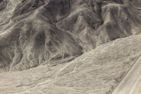 Hilly desert area with interlocking patterns and lines, the geoglyphs and drawings in the desert near Nasca and Palpa in Peru