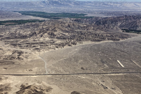 Wide desert-like landscape with mountains and valleys up to the horizon, the desert landscape near Nasca in Peru