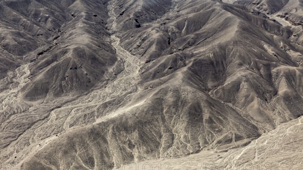Hilly desert landscape with numerous engraved lines, geoglyphs and drawings in the desert near Nasca and Palpa in Peru