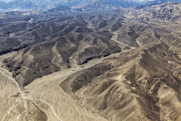 Barren mountain landscape with deep valleys and gentle elevations, the desert landscape near Nasca in Peru