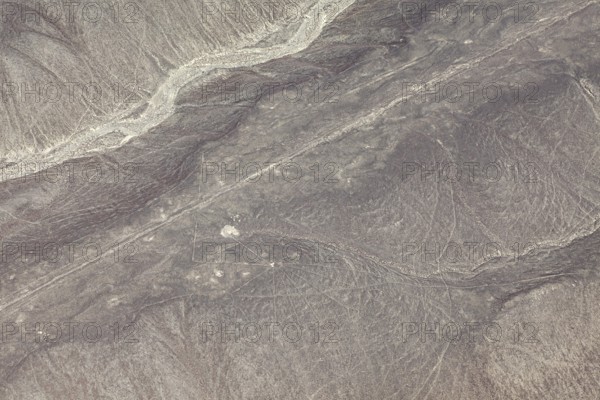Dry, sandy landscape with distinctive lines and patterns, the geoglyphs and drawings in the desert near Nasca and Palpa in Peru
