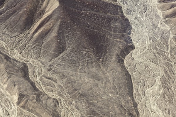 Patterns and lines span a rugged mountain landscape, the geoglyphs and drawings in the desert near Nasca and Palpa in Peru