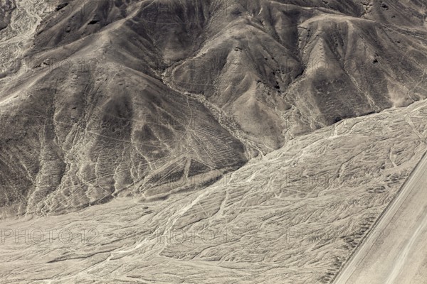 Hilly landscape with incised lines and patterns in the desert, the geoglyphs and drawings in the desert near Nasca and Palpa in Peru