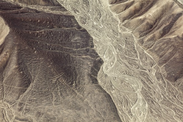 Barren desert hills with clear line formations from the air, the geoglyphs and images in the desert near Nasca and Palpa in Peru