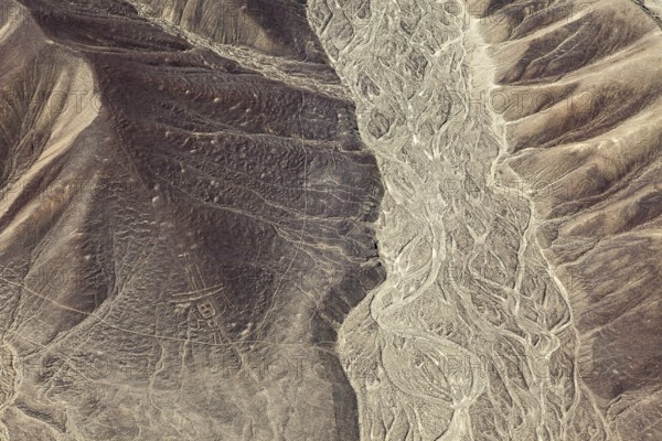 Hilly desert landscape with visible ancient lines from the air, the geoglyphs and paintings in the desert near Nasca and Palpa in Peru